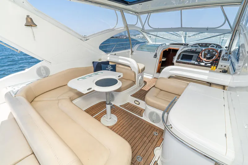 Slide: The Image of Luxury interior of 2000 Fairline 48 Targa yacht with beige seating and wooden flooring. - 19