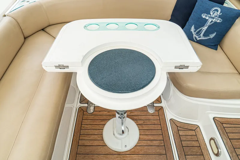 Slide: The Image of Luxury seating area on 2000 Fairline 48 Targa yacht with wooden flooring and nautical decor. - 21