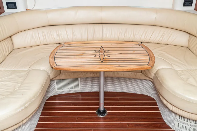 Slide: The Image of Fairline 48 Targa 2000 yacht interior with beige leather seating and wooden table. - 34