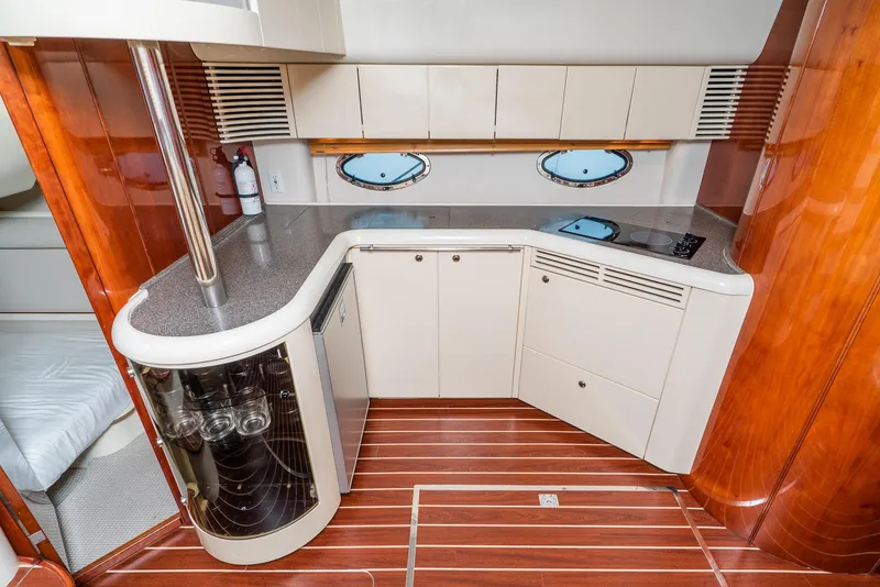 Slide: The Image of Interior of 2000 Fairline 48 Targa yacht kitchen with modern cabinetry and wood flooring. - 36