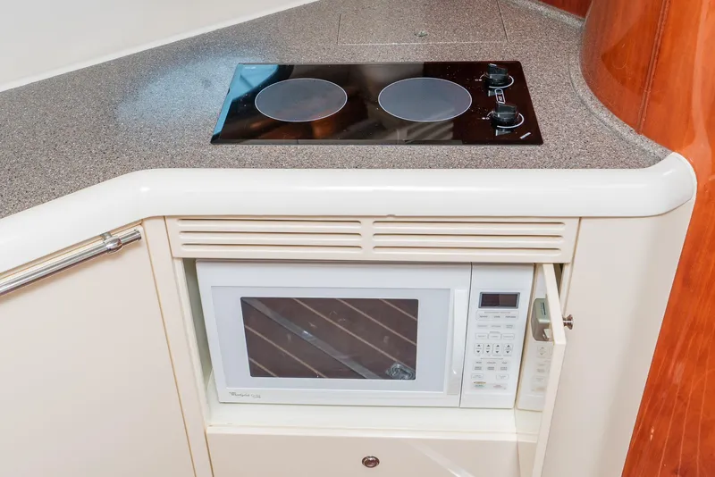Slide: The Image of Kitchen area of 2000 Fairline 48 Targa yacht with stove and microwave. - 38