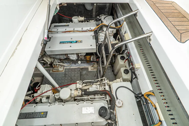 Slide: The Image of Engine compartment of 2000 Fairline 48 Targa yacht, showcasing dual engines and mechanical components. - 48