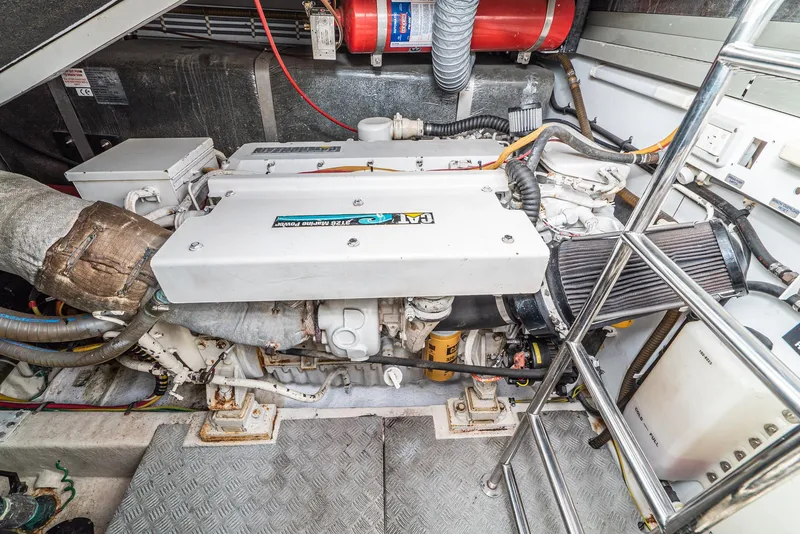 Slide: The Image of Engine room of 2000 Fairline 48 Targa yacht, showcasing mechanical components and equipment. - 49