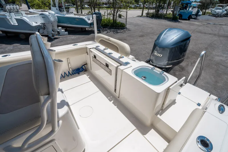 Slide: The Image of 2017 Cobia 237 CC boat interior with Yamaha 300 engine, featuring seating and storage. - 11
