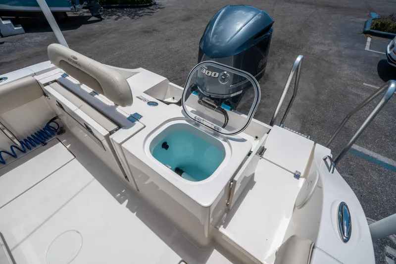 Slide: The Image of 2017 Cobia 237 CC boat with Yamaha 300 engine and open livewell. - 13
