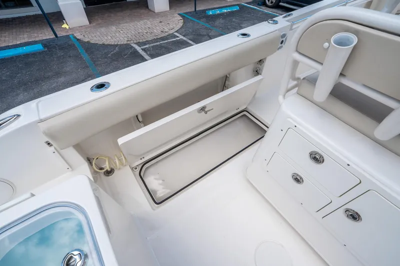 Slide: The Image of 2017 Cobia 237 CC boat interior with storage compartments and seating. - 15