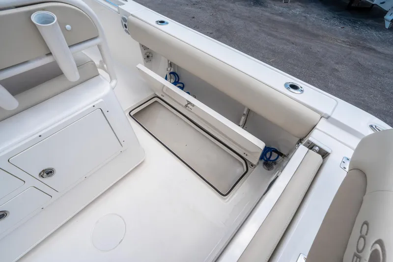 Slide: The Image of 2017 Cobia 237 CC boat interior with storage compartment and seating. - 16