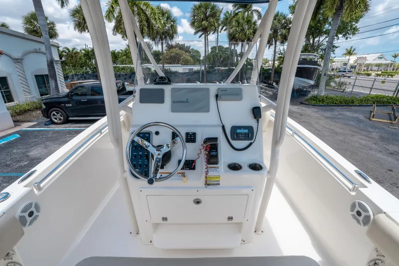 Slide: The Image of 2017 Cobia 237 CC boat console with steering wheel and Garmin navigation system. - 17