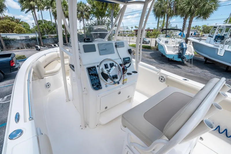 Slide: The Image of 2017 Cobia 237 CC boat interior with helm, seating, and navigation equipment. - 19