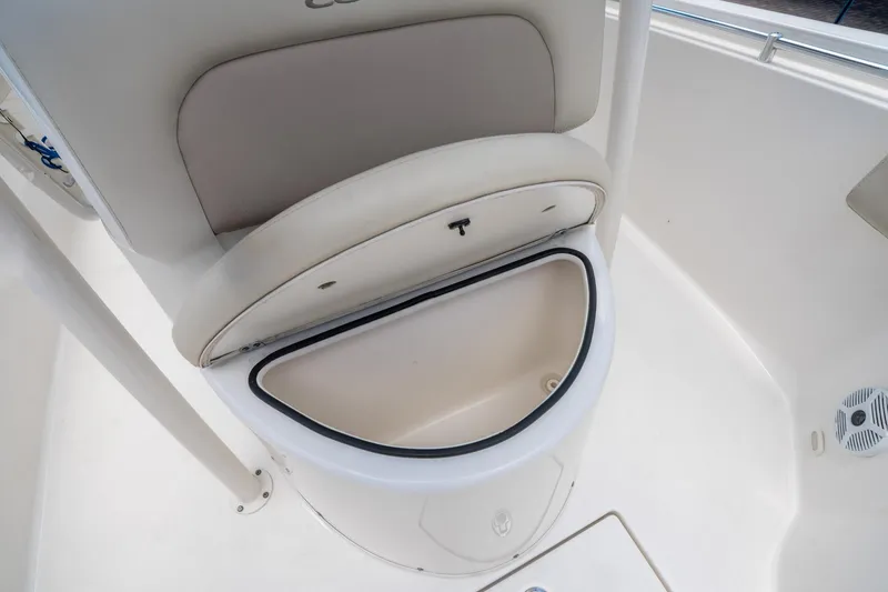 Slide: The Image of 2017 Cobia 237 CC boat storage compartment with open lid, showcasing interior space. - 31