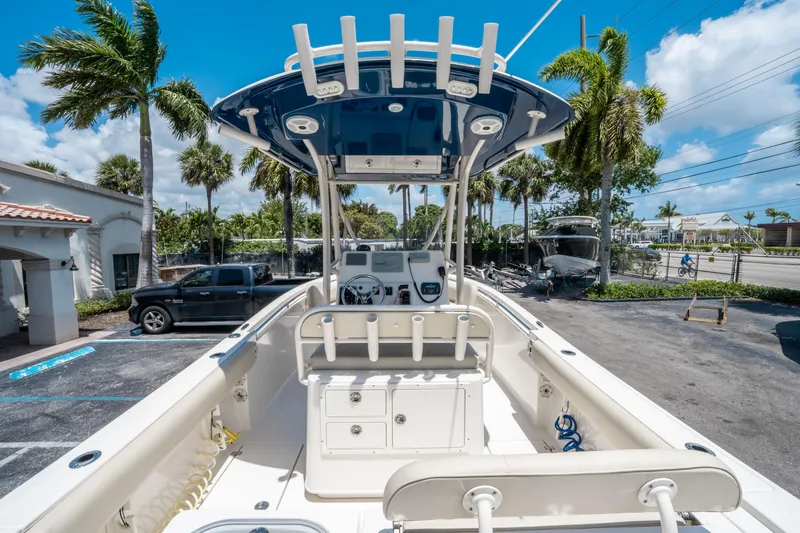 Slide: The Image of 2017 Cobia 237 CC boat with center console, parked outdoors under clear blue sky. - 9