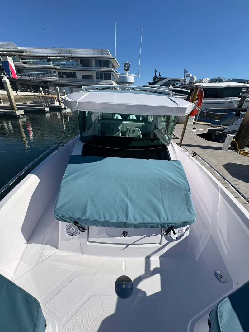 Slide: The Image of 2019 Axopar Brabus boat docked at a marina under clear blue skies. - 11
