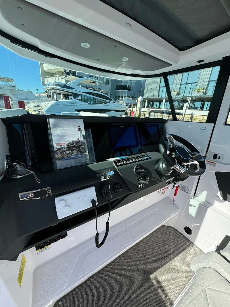 Slide: The Image of 2019 Axopar Brabus boat cockpit with modern controls and steering wheel. - 3