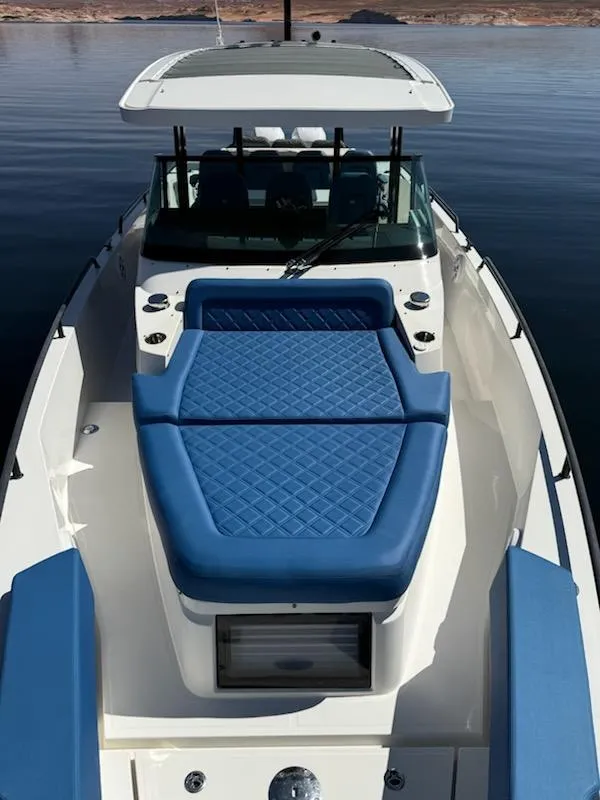 Slide: The Image of 2019 Axopar Brabus boat with blue cushioned seating on calm water. - 6