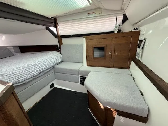 Slide: The Image of 2019 Axopar Brabus cabin interior with modern seating and wooden cabinetry. - 9