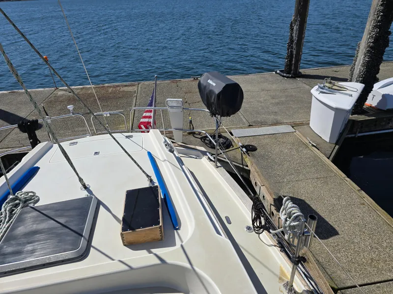 Slide: The Image of 1985 Pearson 385 sailboat docked, featuring deck details and marina view. - 11
