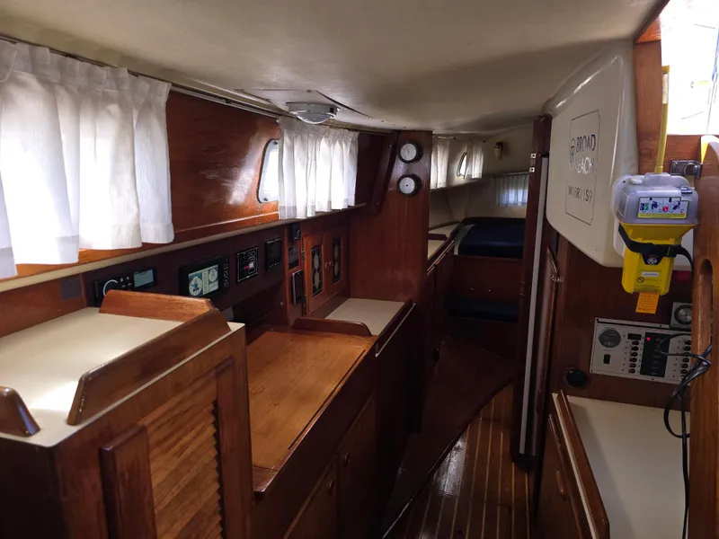 Slide: The Image of Interior of a 1985 Pearson 385 sailboat with wood paneling and navigation equipment. - 18