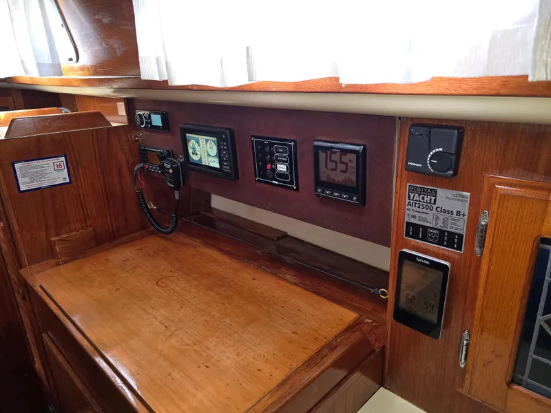 Slide: The Image of Navigation station of a 1985 Pearson 385 yacht with modern instruments and wood finish. - 19