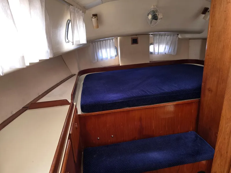 Slide: The Image of Cozy cabin interior of 1985 Pearson 385 sailboat with blue bedding and wooden furnishings. - 20
