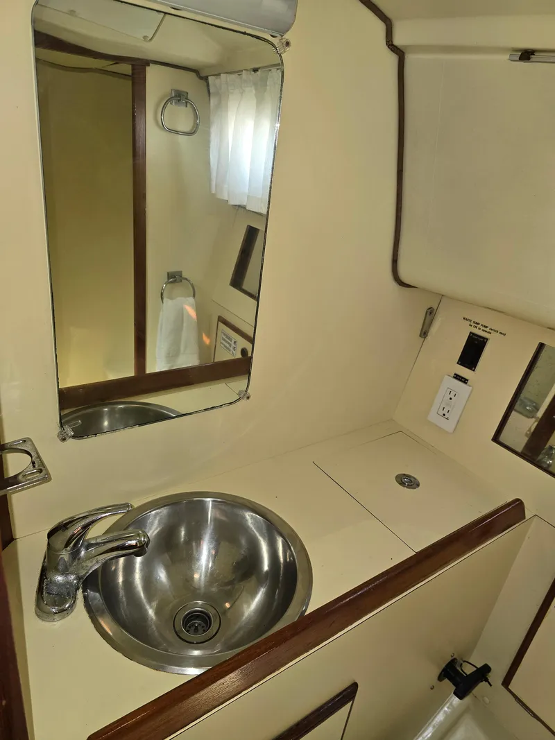 Slide: The Image of 1985 Pearson 385 yacht bathroom with sink, mirror, and electrical outlet. - 22