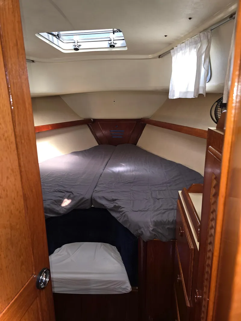 Slide: The Image of Cozy cabin interior of 1985 Pearson 385 sailboat with bed and wooden cabinetry. - 25