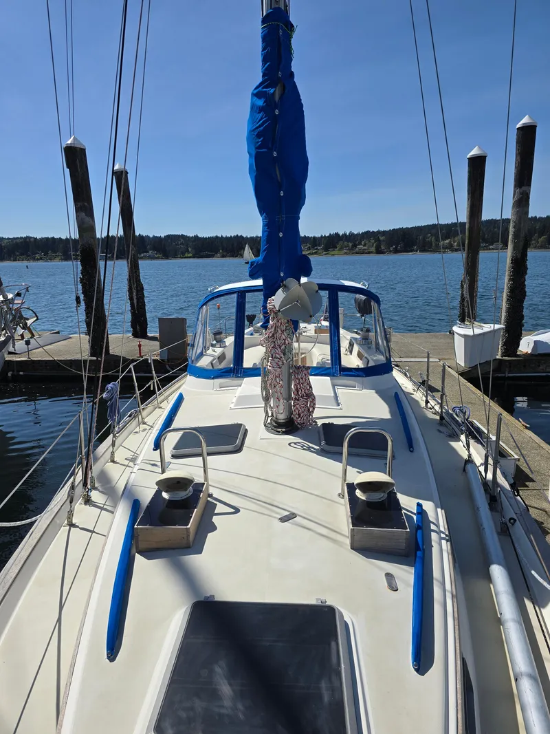 Slide: The Image of 1985 Pearson 385 sailboat docked at a marina on a sunny day. - 6