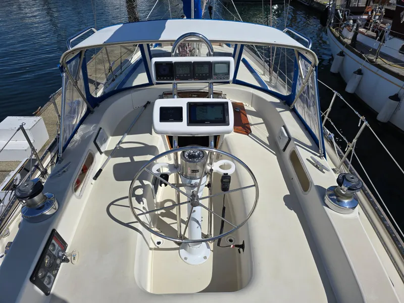 Slide: The Image of Cockpit of 1985 Pearson 385 sailboat with steering wheel and navigation instruments. - 8