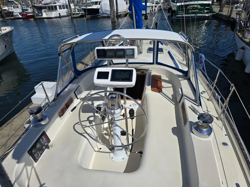 Slide: The Image of Cockpit of a 1985 Pearson 385 sailboat docked at a marina. - 9
