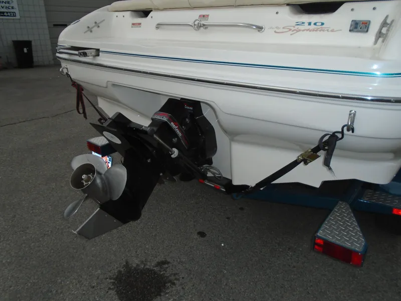 Slide: The Image of 1997 Sea Ray 210 Bowrider boat stern with outboard motor and propeller. - 3