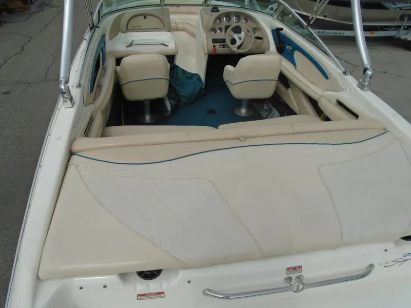 Slide: The Image of 1997 Sea Ray 210 Bowrider interior with seating and dashboard view. - 4