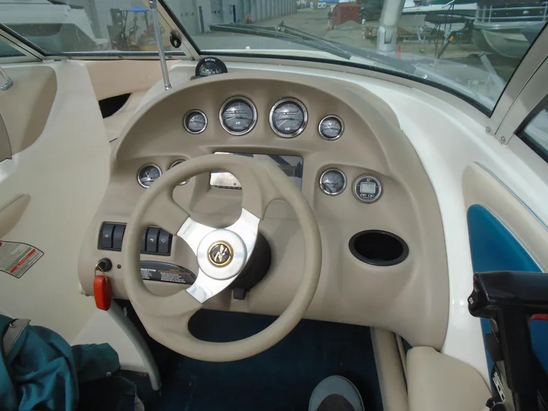 Slide: The Image of 1997 Sea Ray 210 Bowrider dashboard with steering wheel and gauges. - 5