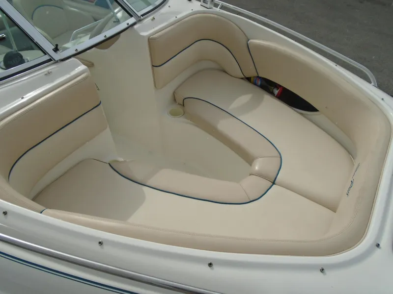 Slide: The Image of 1997 Sea Ray 210 Bowrider boat interior with beige seating and sleek design. - 6