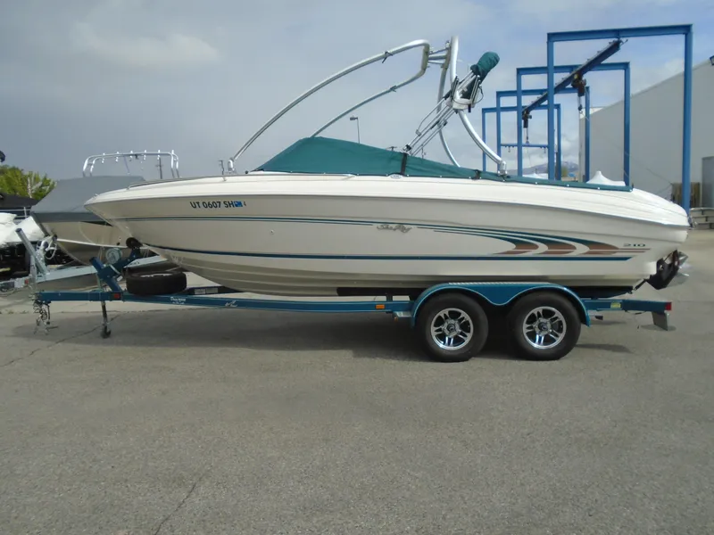 Slide: The Image of 1997 Sea Ray 210 Bowrider on trailer, parked outdoors, side view. - 9