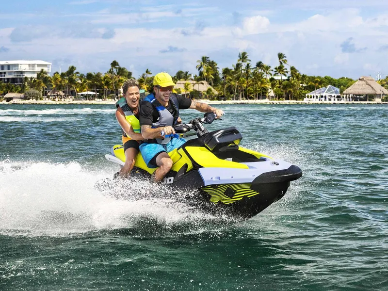 Slide: The Image of Couple enjoying a ride on a 2024 Sea-Doo SPARK TRIXX 3UP IBR jet ski. - 6