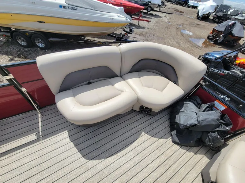 Slide: The Image of Luxurious seating on 2021 Landau 220 Atlantis boat, featuring beige upholstery and spacious deck. - 11