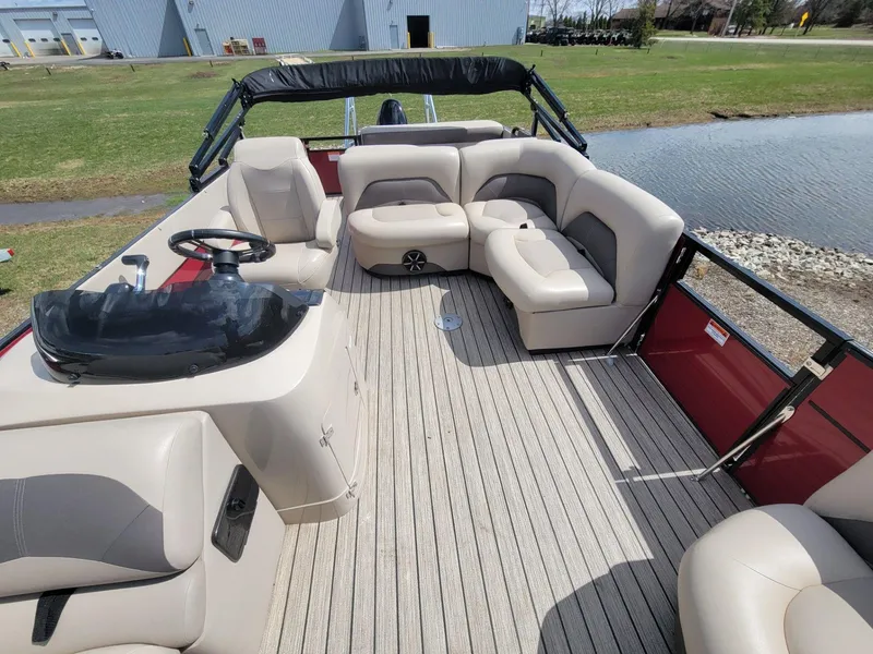 Slide: The Image of 2021 Landau 220 Atlantis pontoon boat with spacious seating and modern helm. - 13