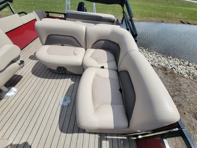 Slide: The Image of Luxurious seating on 2021 Landau 220 Atlantis boat, featuring beige upholstery and spacious layout. - 14