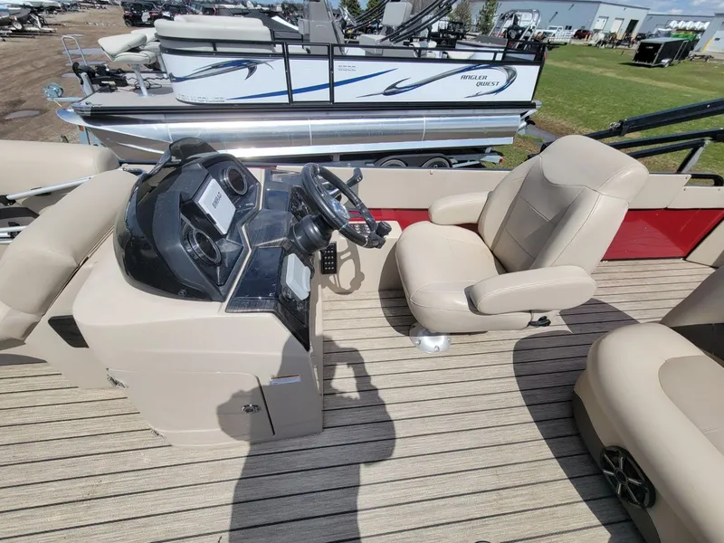 Slide: The Image of 2021 Landau 220 Atlantis boat interior with beige seating and control panel. - 15