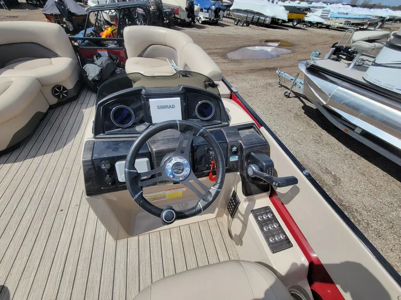 Slide: The Image of 2021 Landau 220 Atlantis boat dashboard with steering wheel and controls. - 18