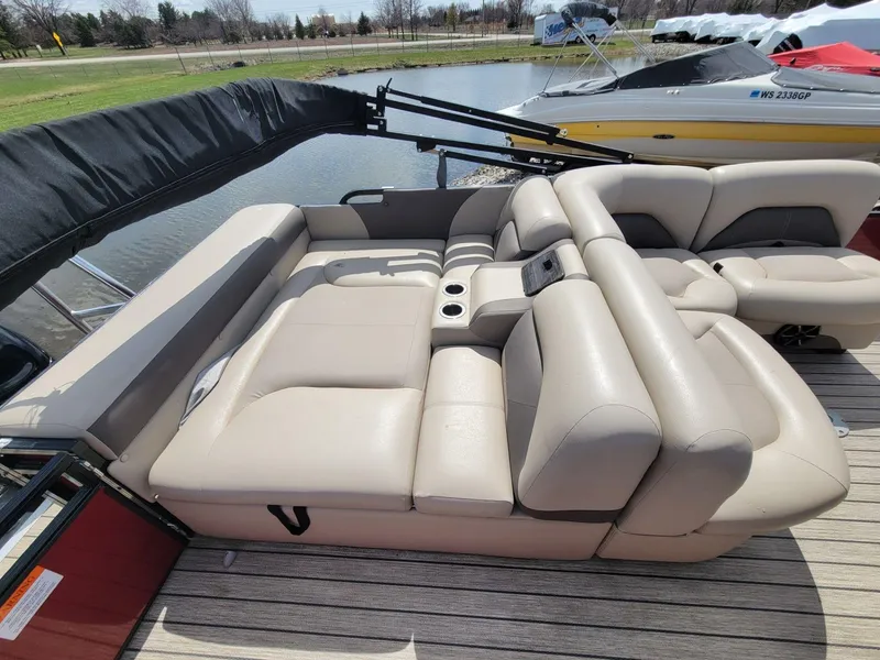 Slide: The Image of Luxurious seating on 2021 Landau 220 Atlantis boat, featuring beige upholstery and cup holders. - 21