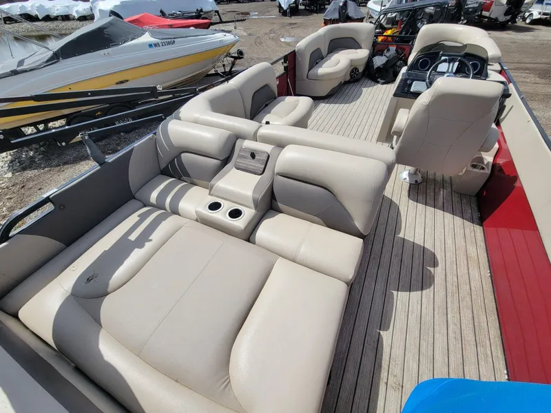 Slide: The Image of 2021 Landau 220 Atlantis pontoon boat with spacious beige seating and modern interior design. - 23