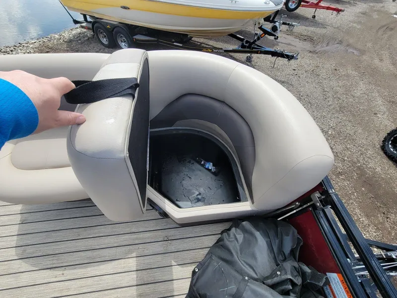 Slide: The Image of Open storage compartment in 2021 Landau 220 Atlantis boat seat, revealing interior space. - 29