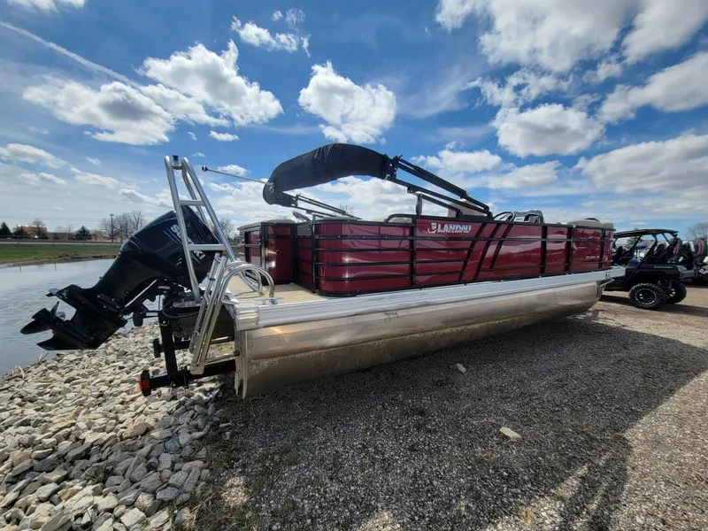Slide: The Image of 2021 Landau 220 Atlantis pontoon boat on rocky shore under blue sky. - 4