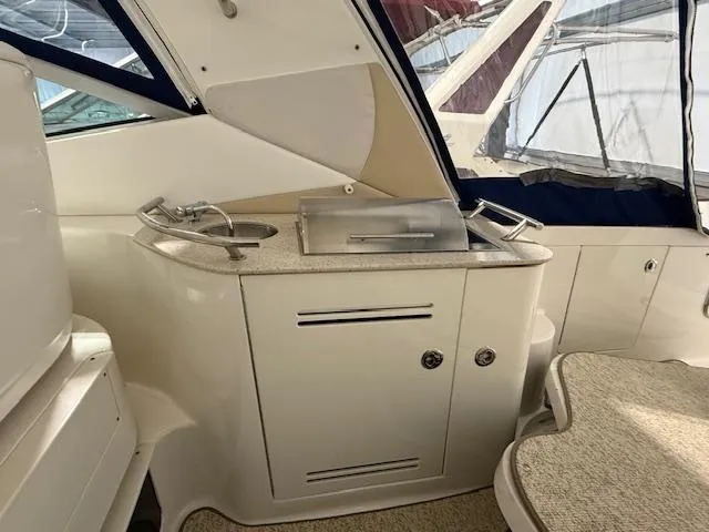 Slide: The Image of 2009 Sea Ray 350 Sundancer yacht interior with kitchenette and seating area. - 10