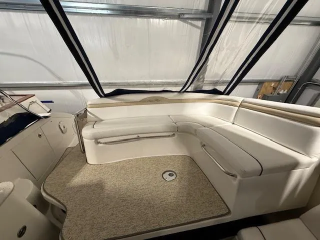 Slide: The Image of 2009 Sea Ray 350 Sundancer interior with white seating and carpeted flooring. - 11