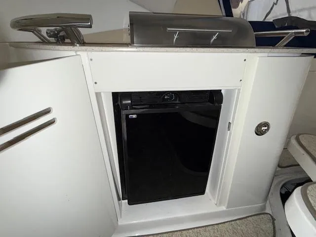 Slide: The Image of 2009 Sea Ray 350 Sundancer kitchenette with mini fridge and grill. - 13
