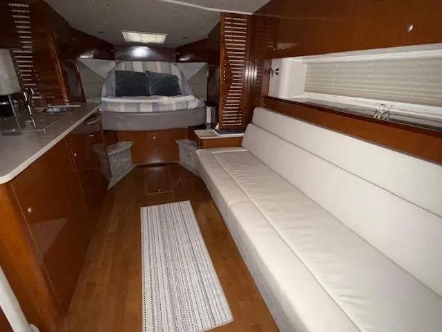 Slide: The Image of Interior of 2009 Sea Ray 350 Sundancer with white sofa and cozy bed. - 19