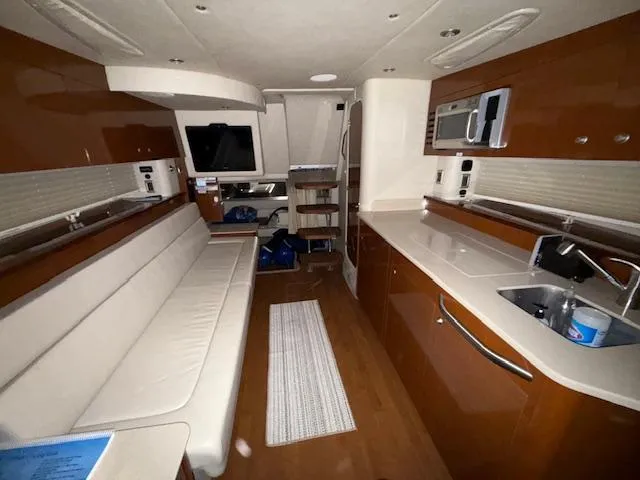 Slide: The Image of Interior of a 2009 Sea Ray 350 Sundancer yacht with modern amenities and sleek design. - 22
