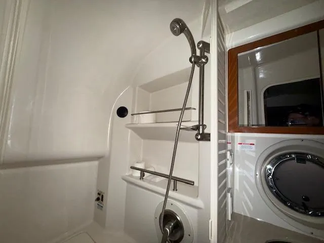 Slide: The Image of Interior of 2009 Sea Ray 350 Sundancer bathroom with shower and porthole. - 28