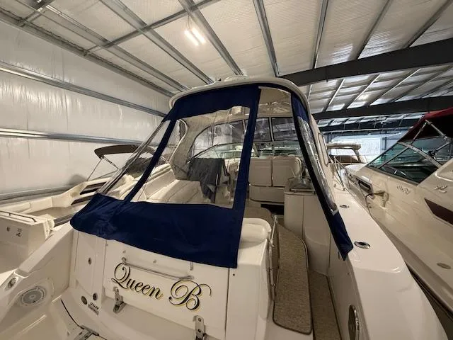 Slide: The Image of 2009 Sea Ray 350 Sundancer "Queen B" in storage, featuring blue canvas cover. - 3